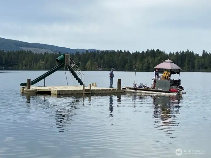Swimming area with floating dock and slide. Swimming area with floating dock and slide.