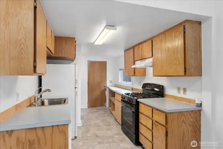 Unit 2307 kitchen featuring gas stove. Unit 2307 kitchen featuring gas stove.