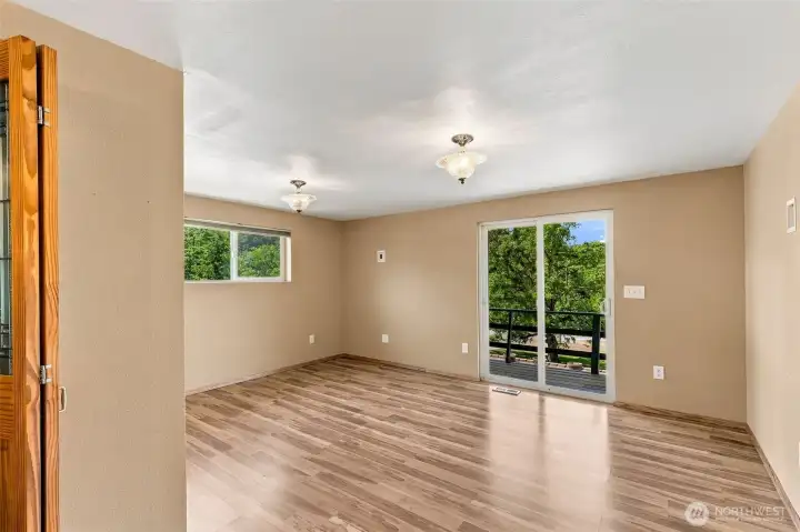 Spacious primary bedroom with walk-in closet and balcony access looking over the property. Spacious primary bedroom with walk-in closet and balcony access looking over the property.