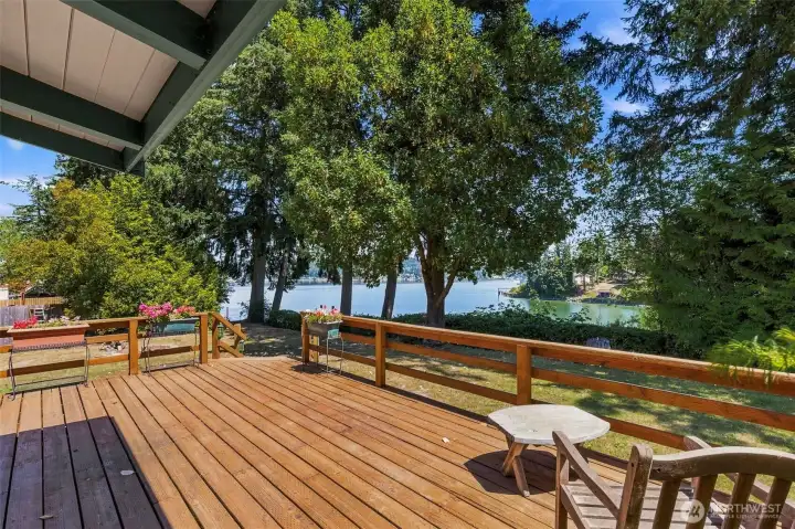Spacious deck overlooking the heirloom orchard with peaceful water views beyond—an inviting setting for outdoor dining, entertaining, or quiet relaxation. Spacious deck overlooking the heirloom orchard with peaceful water views beyond—an inviting setting for outdoor dining, entertaining, or quiet relaxation.