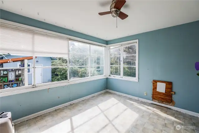 Sun room in the back of the home with an option to build a dog run!