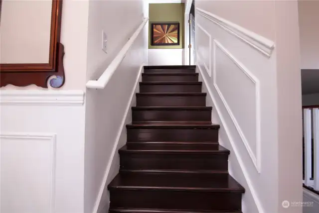 Grand Steps with Chair Railing leads you upstairs.