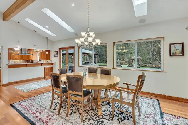 Family dining in the great room, with french doors leading to back decks.