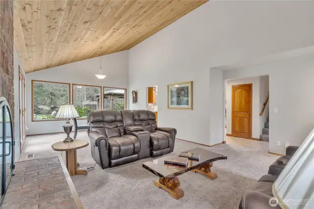 Another view of the living room with large,  river view windows.