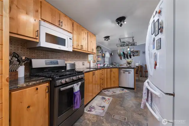 Looking through the kitchen toward the dining area. Notice the newer gas range.