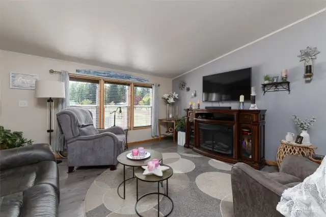 Large living area with an open layout that flows into the kitchen and dining area.
