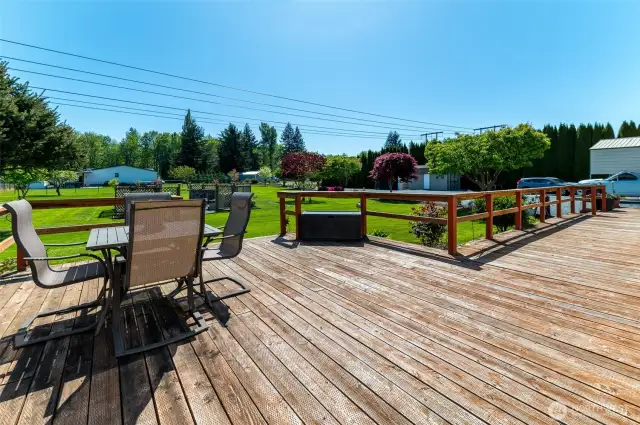 Spacious front deck overlooks the yard and firepit area.