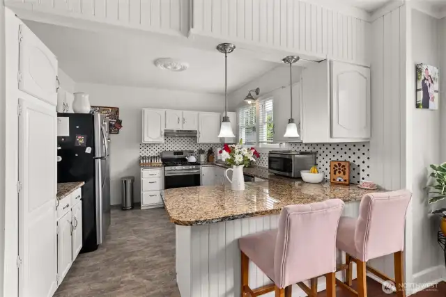 Large kitchen flows into with eat in bar