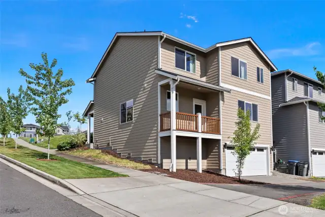 Back of house with 2 Car Garage Parking.