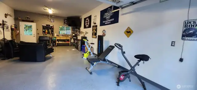 Huge garage with shop space is ideal for car or boat storage, or home gym or office! So many possibilities!