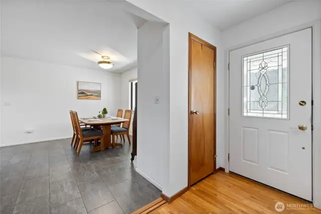 Entryway with hardwood floors and a coat closet