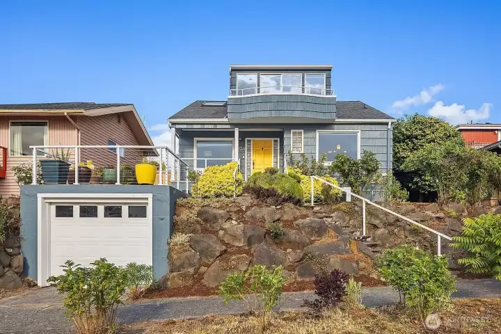 Perched on a quiet street, this home boasts stunning  views of the Puget Sound and Olympic Mountains—from the main floor’s living and dining rooms to the upstairs primary suite and private balcony.