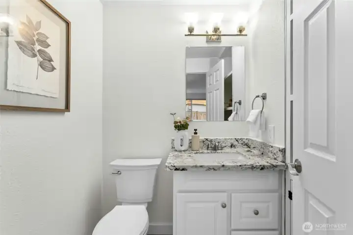 Refreshed powder room with new toilet, fan, vanity.