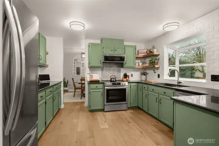 New flooring and subway tile. Cabinets were rearranged and freshly painted.