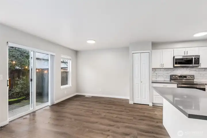 The dining room is situated nicely between the open kitchen and sliding doors to the patio. Great for entertaining in the summer!