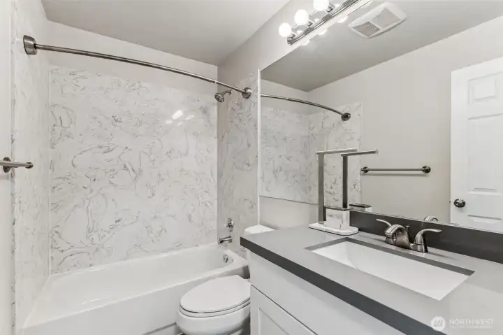 The full upstairs bath serves the 2nd and 3rd bedrooms and has quartz counters.