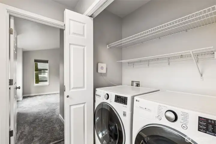 The utility closet with its washer and dryer is conveniently located between all three upstairs bedrooms.