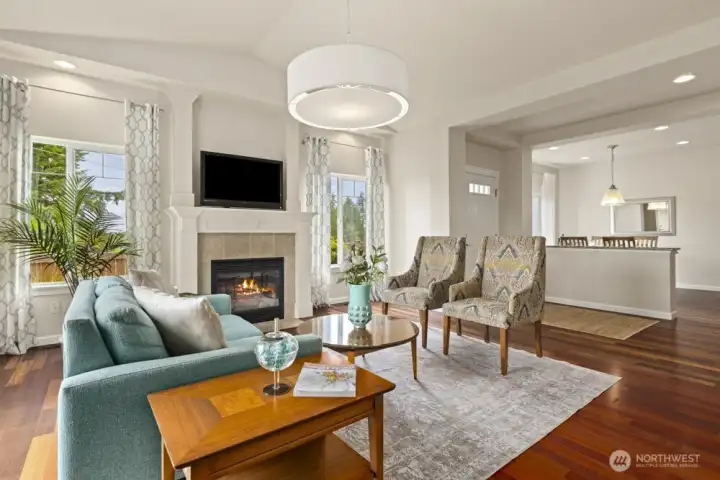 Open flow living room accompanied by a low-maintenance gas fireplace. Stunning hardwood floors stretch throughout the living areas on the main floor. The bedrooms, staircase, and upper-level hallway all have brand new carpeting.