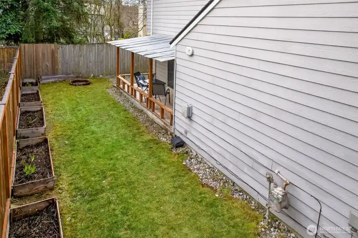 This side yard adds flexibility for everyday living, with a clean, open run of lawn and raised beds along the fence line. It’s a practical bonus area for gardening, storage, or simply keeping things organized and out of sight.