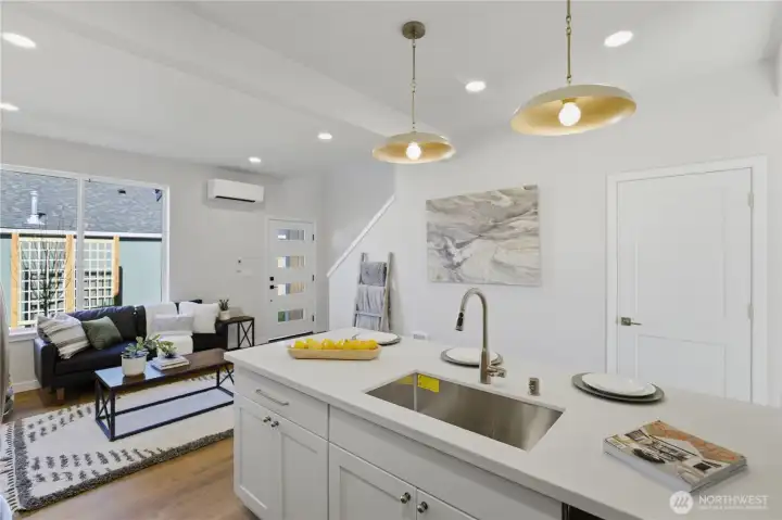 Modern kitchen with quartz countertops, stainless appliances, and island seating