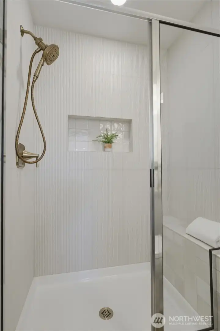 Tile shower and quartz vanity with clean, contemporary design