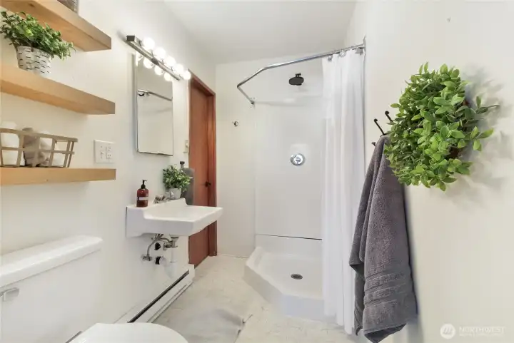 Primary 3/4 bathroom with access to utility room.