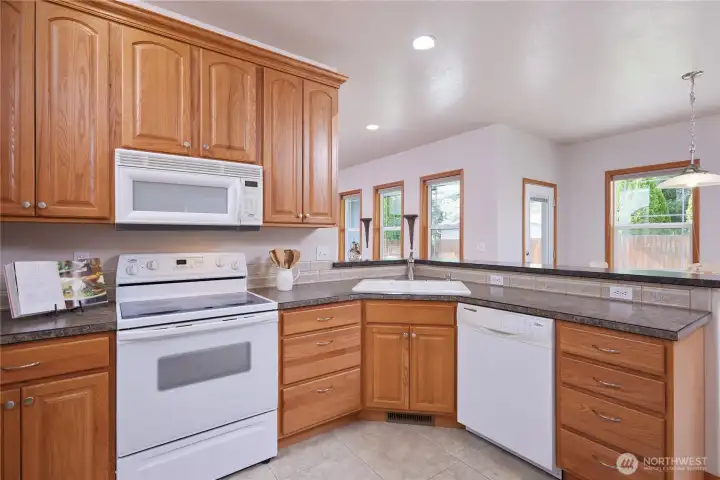 Open but not too open.  The kitchen looks over a breakfast bar into the eating space with some visibility into the living room as well.