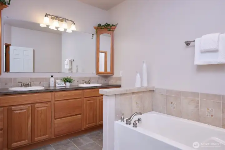 Lay back and relax in this soaking tub - which is just one of the features of this beautiful 5-piece primary bathroom.