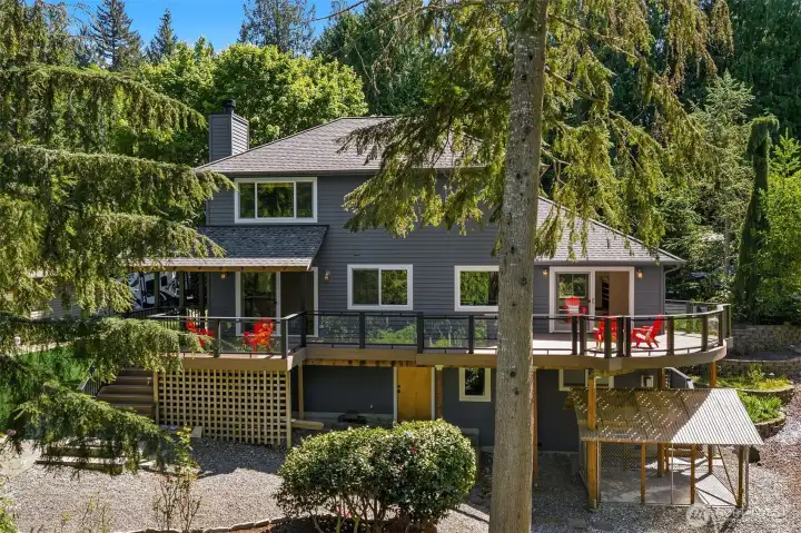 Rear of the home shows the large deck with covered BBQ area with gas hook-up.