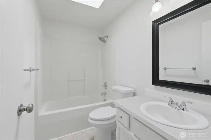 Full bath with skylight, and all white for easy cleaning.