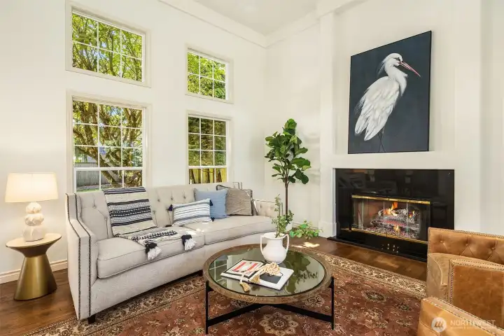 Gorgeous living room with vaulted ceilings and picture windows that frame the beautiful trees outside like a painting. Lots of natural light and flare for the dramatic. This is not a cookie-cutter home.