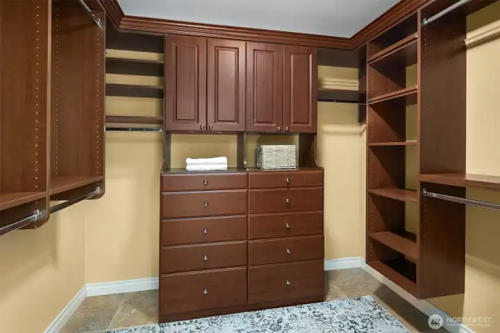 Custom closet with built-in dressers in primary suite