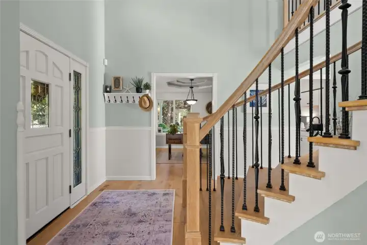 To the left of an entry, a private office with large windows and a custom barn door.