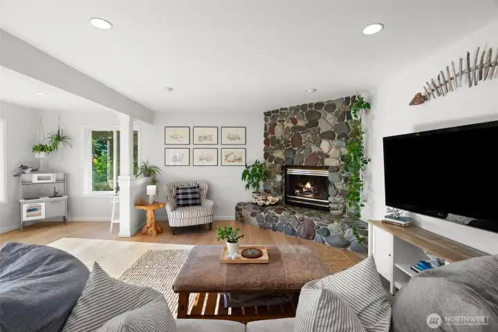 The living room has a seating area to the left to take in the views and one of two main floor propane fireplaces.