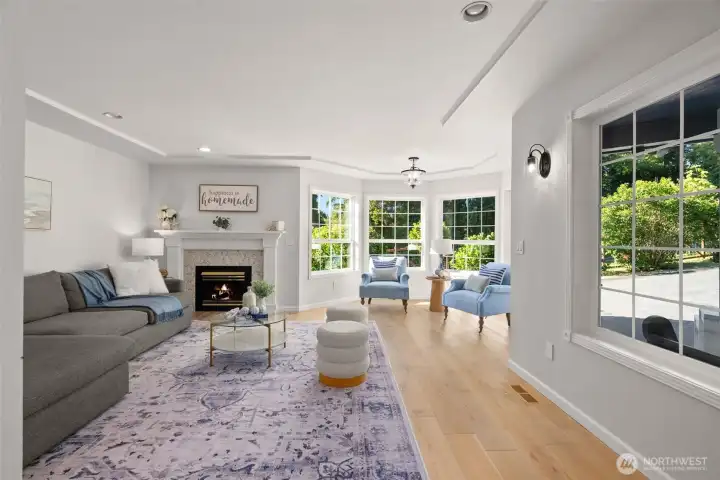 From the right of the front door, this second generously sized formal living or family room features a second main floor fireplace and large windows throughout.