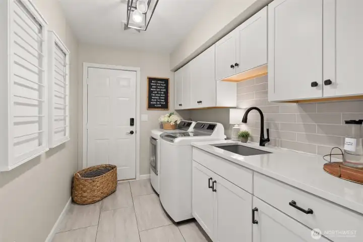 The main floor utility room has quartz counters and storage galore.