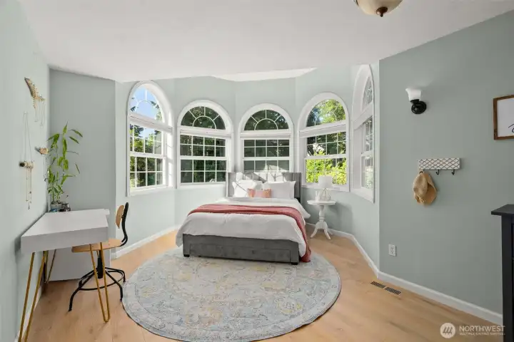 The second of the bedroom upstairs features a turret-like construction and stunning custom windows.