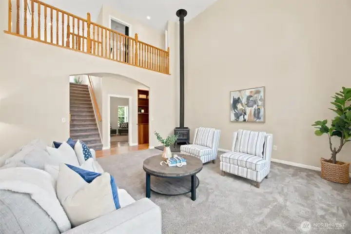 Dramatic two-story great room with soaring ceilings and cozy wood stove Dramatic two-story great room with soaring ceilings and cozy wood stove