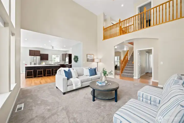 Open-concept living with soaring ceilings and seamless flow to the kitchen Open-concept living with soaring ceilings and seamless flow to the kitchen