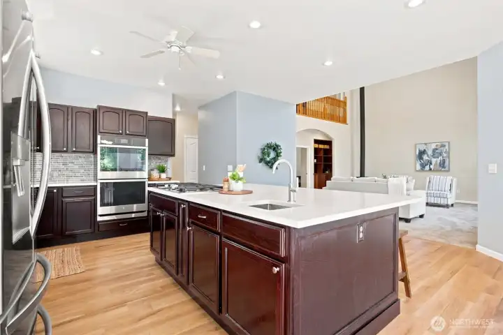 Expansive kitchen with oversized island, double ovens, and open-concept design. Expansive kitchen with oversized island, double ovens, and open-concept design.