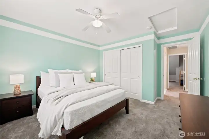 Bright upper-level bedroom featuring a tray ceiling, fresh paint, and generous closet space Bright upper-level bedroom featuring a tray ceiling, fresh paint, and generous closet space