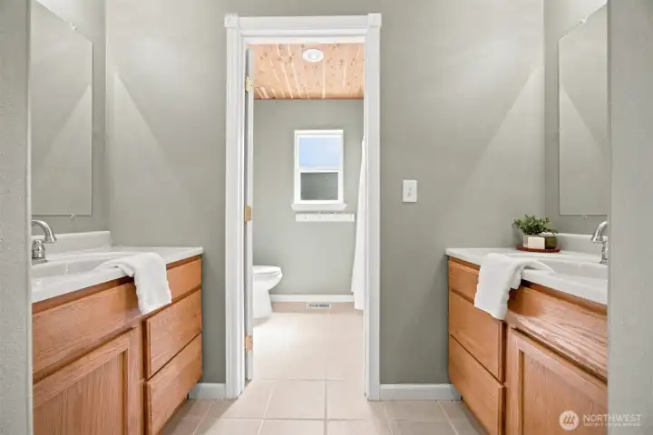 Dual-sink upper-level bathroom designed to comfortably serve the secondary bedrooms Dual-sink upper-level bathroom designed to comfortably serve the secondary bedrooms