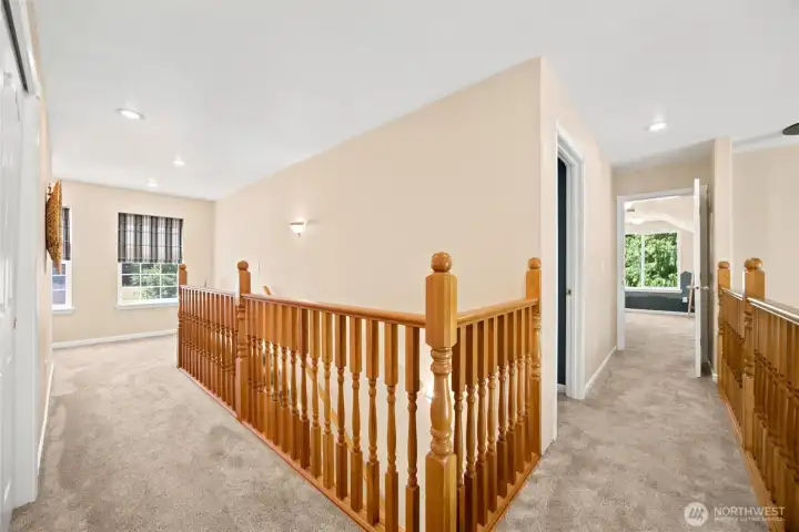 Upper-level landing overlooking the dramatic two-story great room Upper-level landing overlooking the dramatic two-story great room