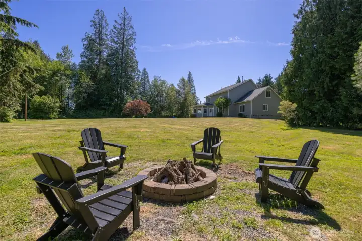 Gather around the fire pit and enjoy peaceful evenings overlooking the expansive backyard Gather around the fire pit and enjoy peaceful evenings overlooking the expansive backyard