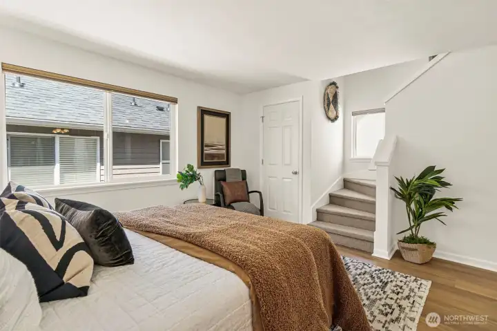 Primary bedroom suite with staircase up to private rooftop deck