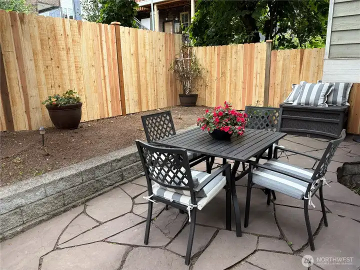 Rear patio fully enclosed by new fence.
