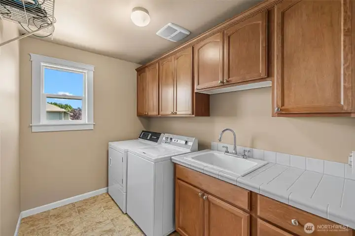 Laundry with lots of cabinets and sink Laundry with lots of cabinets and sink