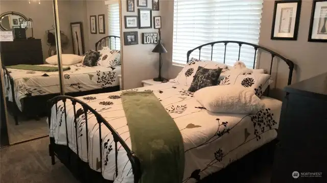 Private rear bedroom with 2 windows and mirrored closet.