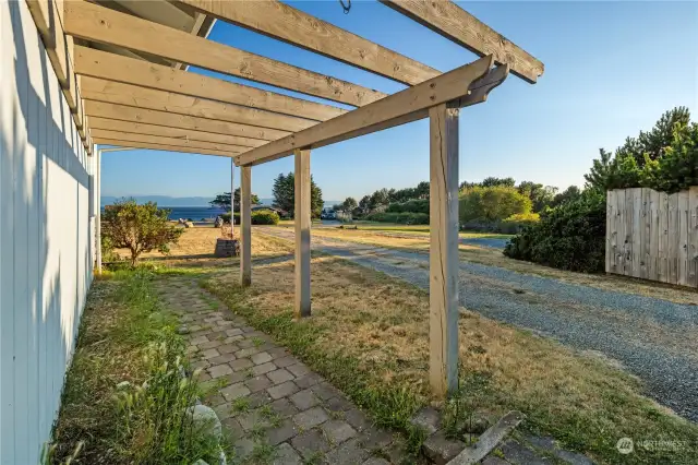 An attached pergola on the side of the house.