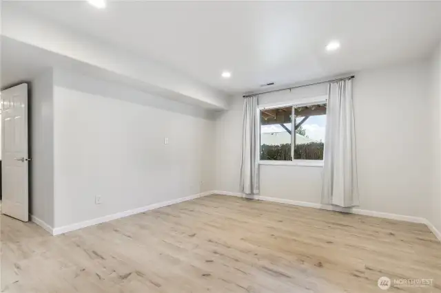 Lower Level Bedroom with Access to Bathroom and Laundry Arera